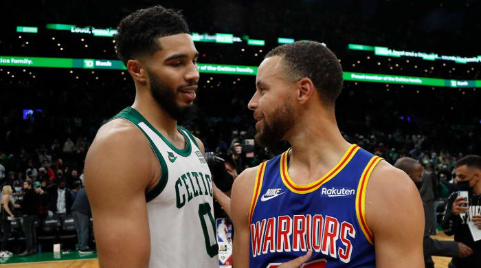 Dec 17, 2021; Boston, Massachusetts, USA; Boston Celtics forward Jayson Tatum (0) talks with Golden State Warriors guard Stephen Curry (30) after their game at TD Garden.